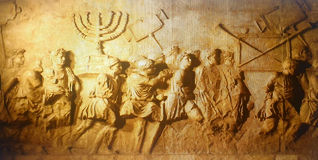Roman Triumphal arch panel copy from Beth Hatefutsoth, showing spoils of Jerusalem temple. Image by Wikimedia Commons.