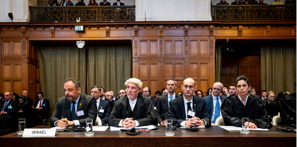 Picture: "The Israeli delegation at the International Court of Justice (ICJ) public hearings on the request for the indication of provisional measures submitted by South Africa in the case South Africa v. Israel, January 11, 2024. (Photo: International Court of Justice)" Picture and caption from Mondoweiss.net